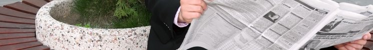 Image of a pen on top of papers with statistical reports containing a line graph.